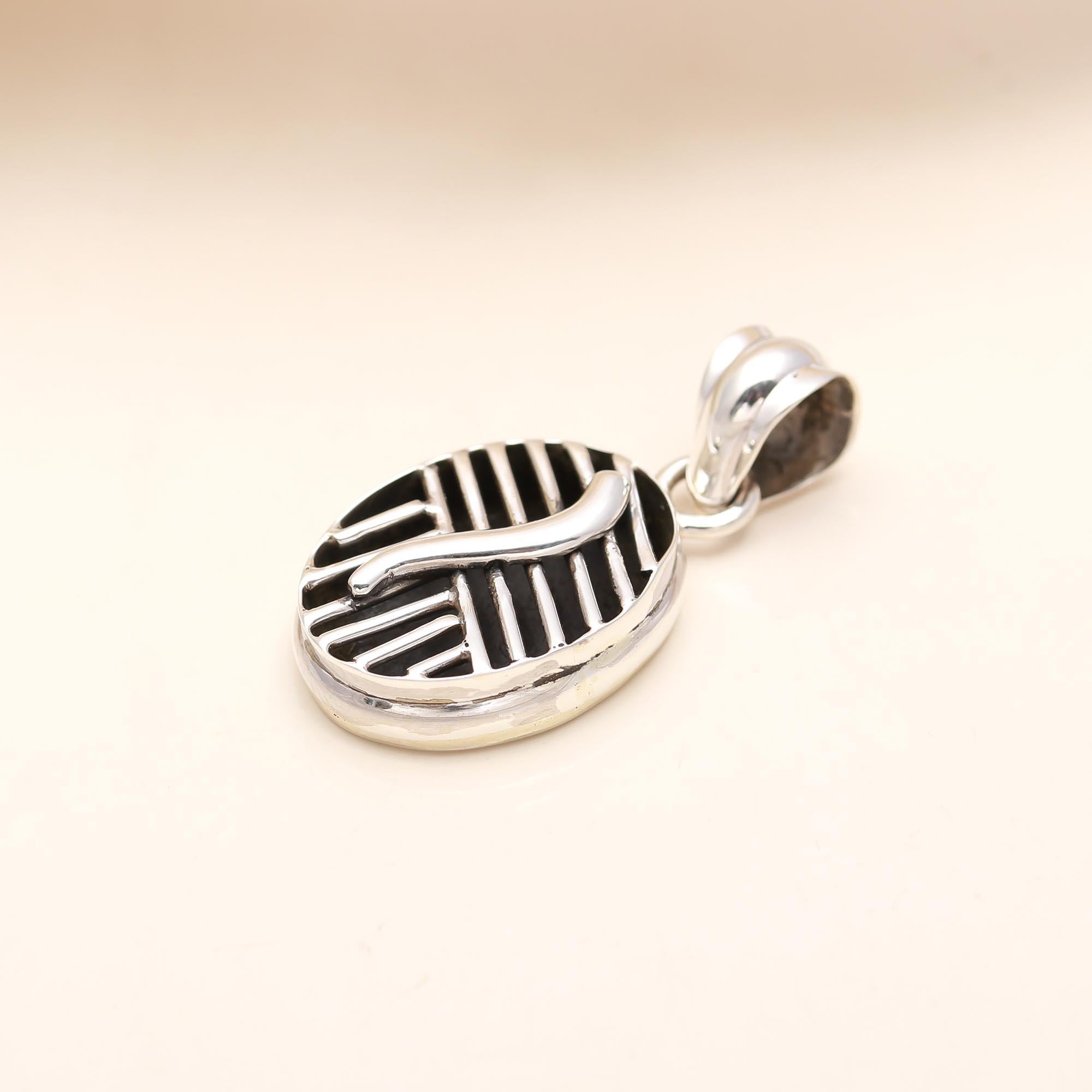 The Modern Labyrinth: Geometric Silver & Black Oval Pendant