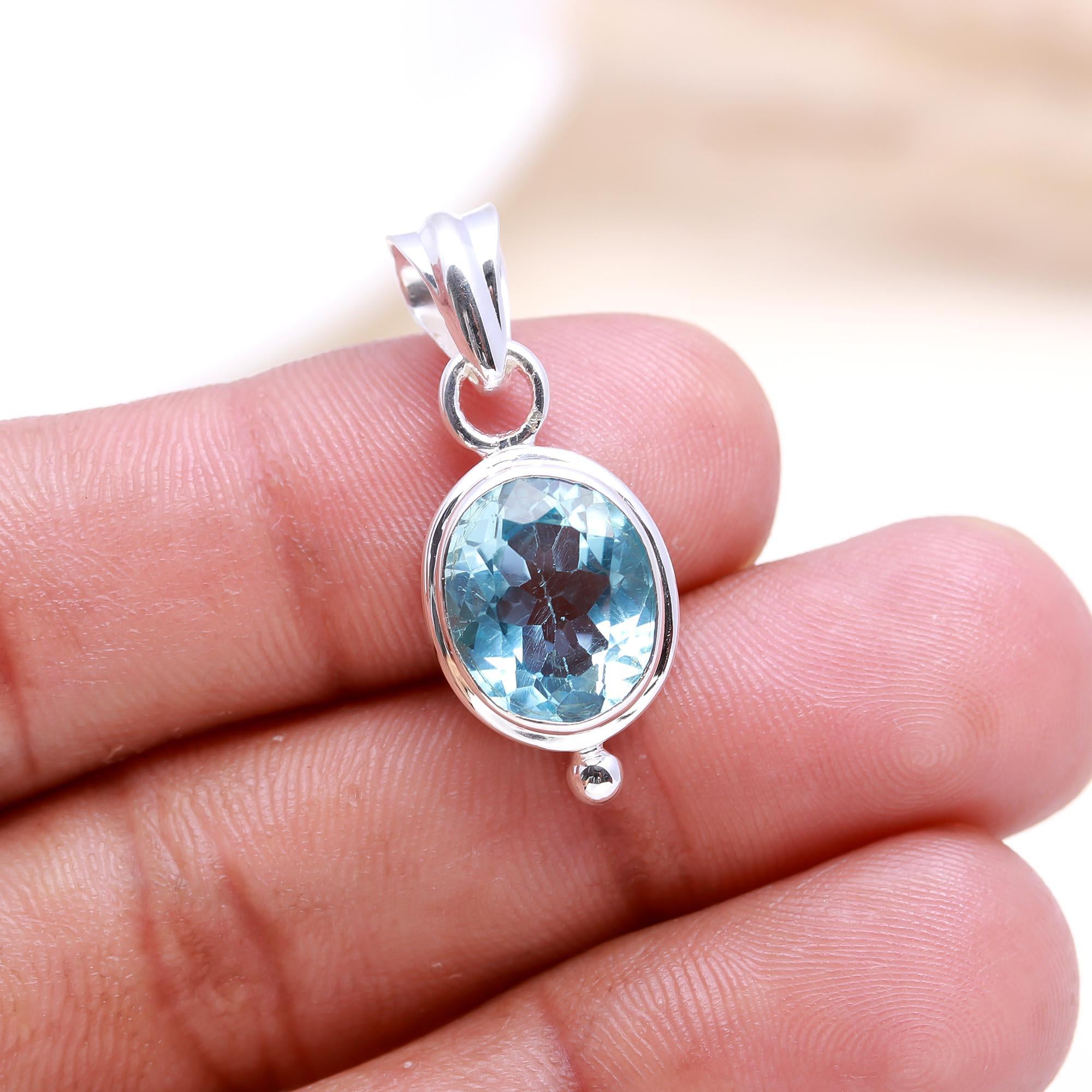The Serene Oval: Blue Topaz East-West Pendant
