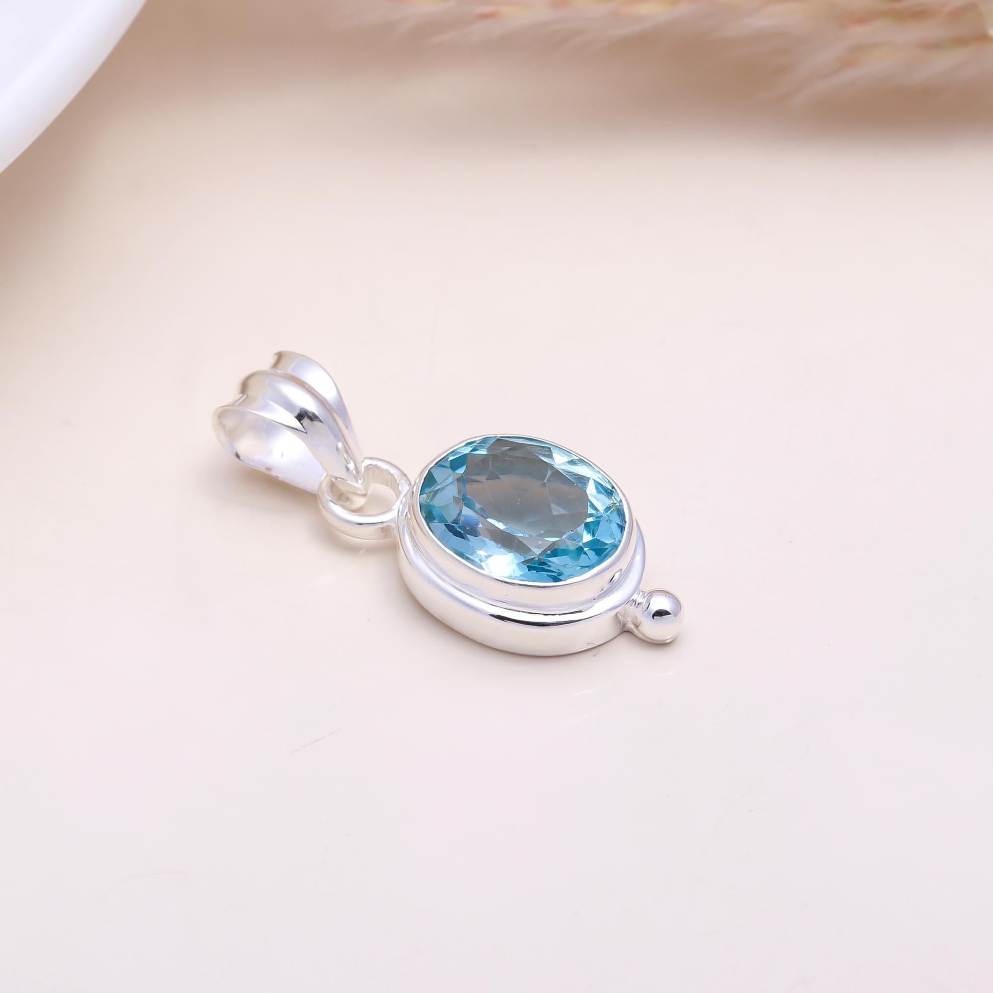 The Serene Oval: Blue Topaz East-West Pendant