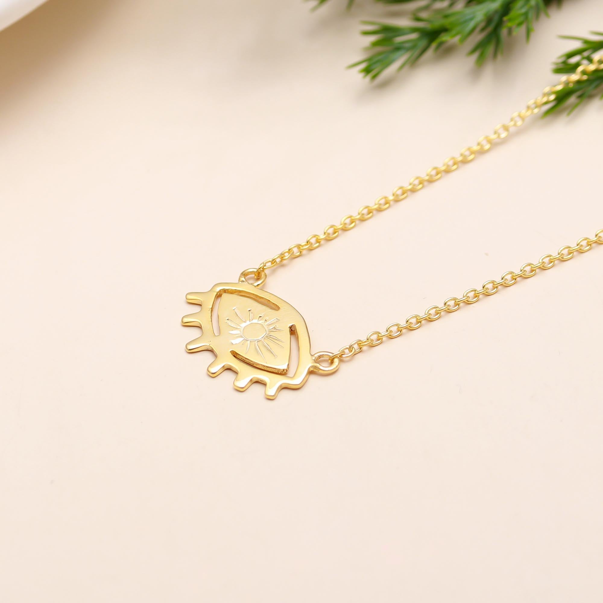 The Solar Gaze: Gold Eye & Sunburst Pendant Necklace