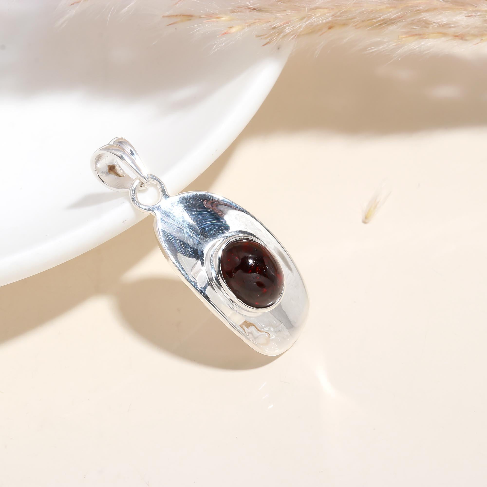 The Sculptural Shield: Modern Garnet Polished Silver Pendant