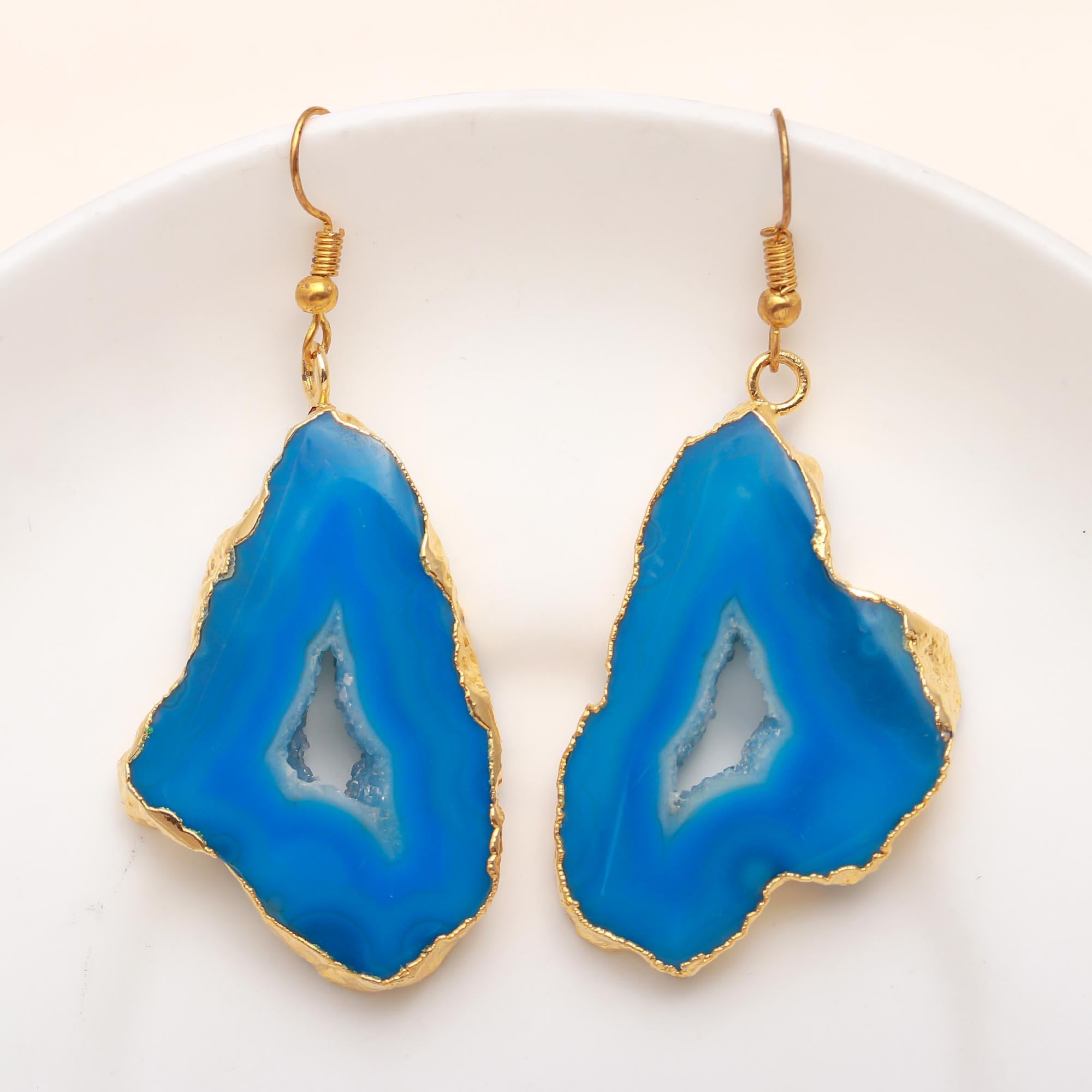 A pair of gold-plated stud earrings featuring a blue agate geode design.