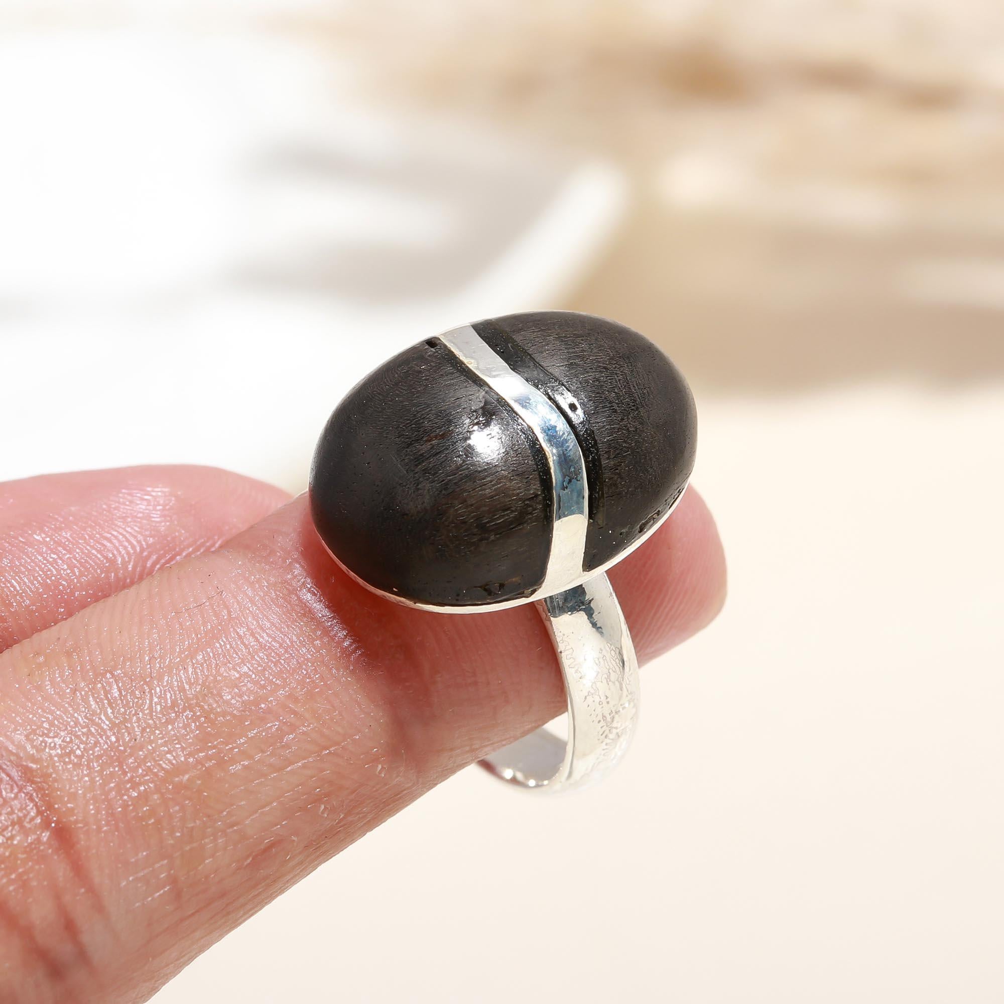 Elegant ebony wood statement ring on finger