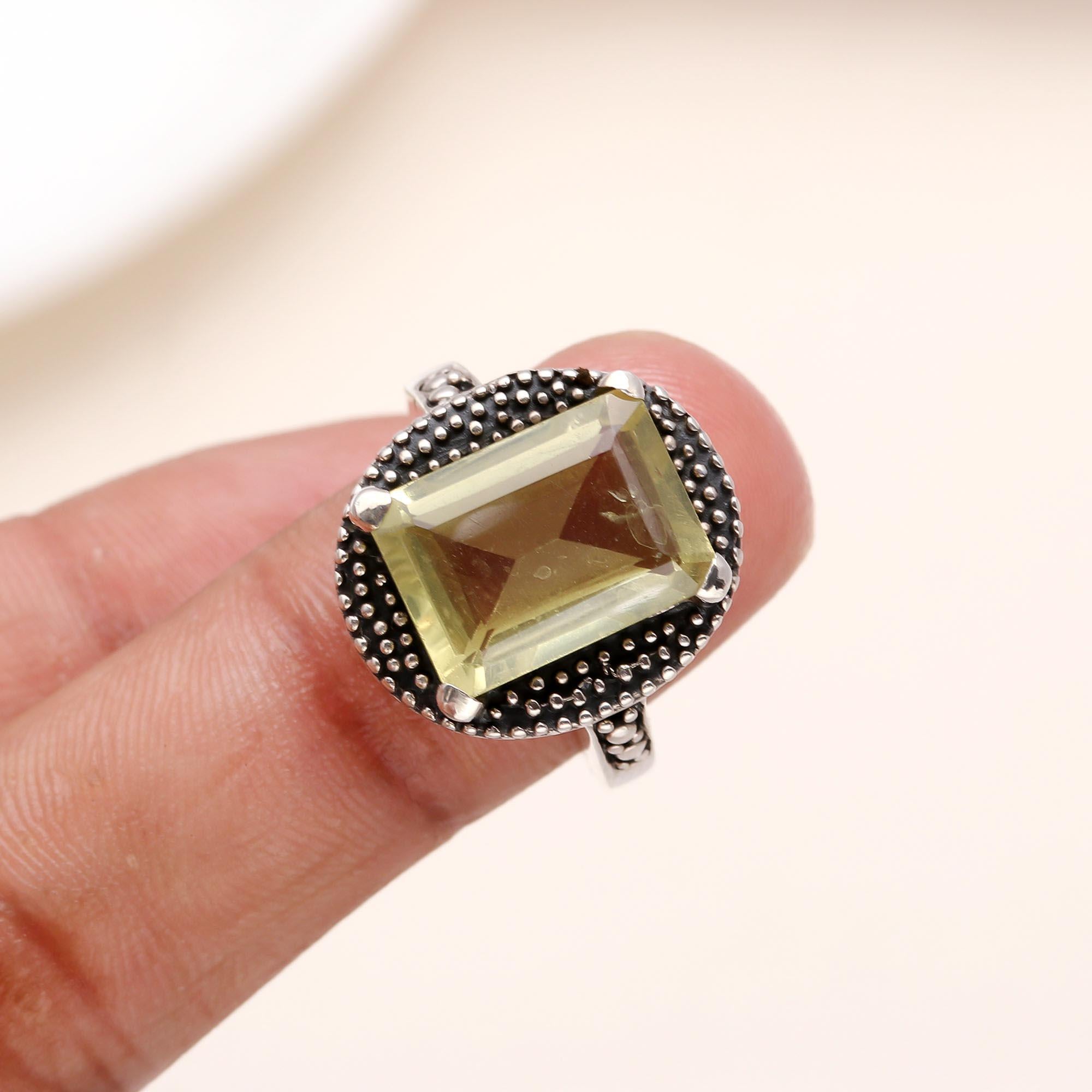 Elegant emerald cut lemon quartz ring on finger