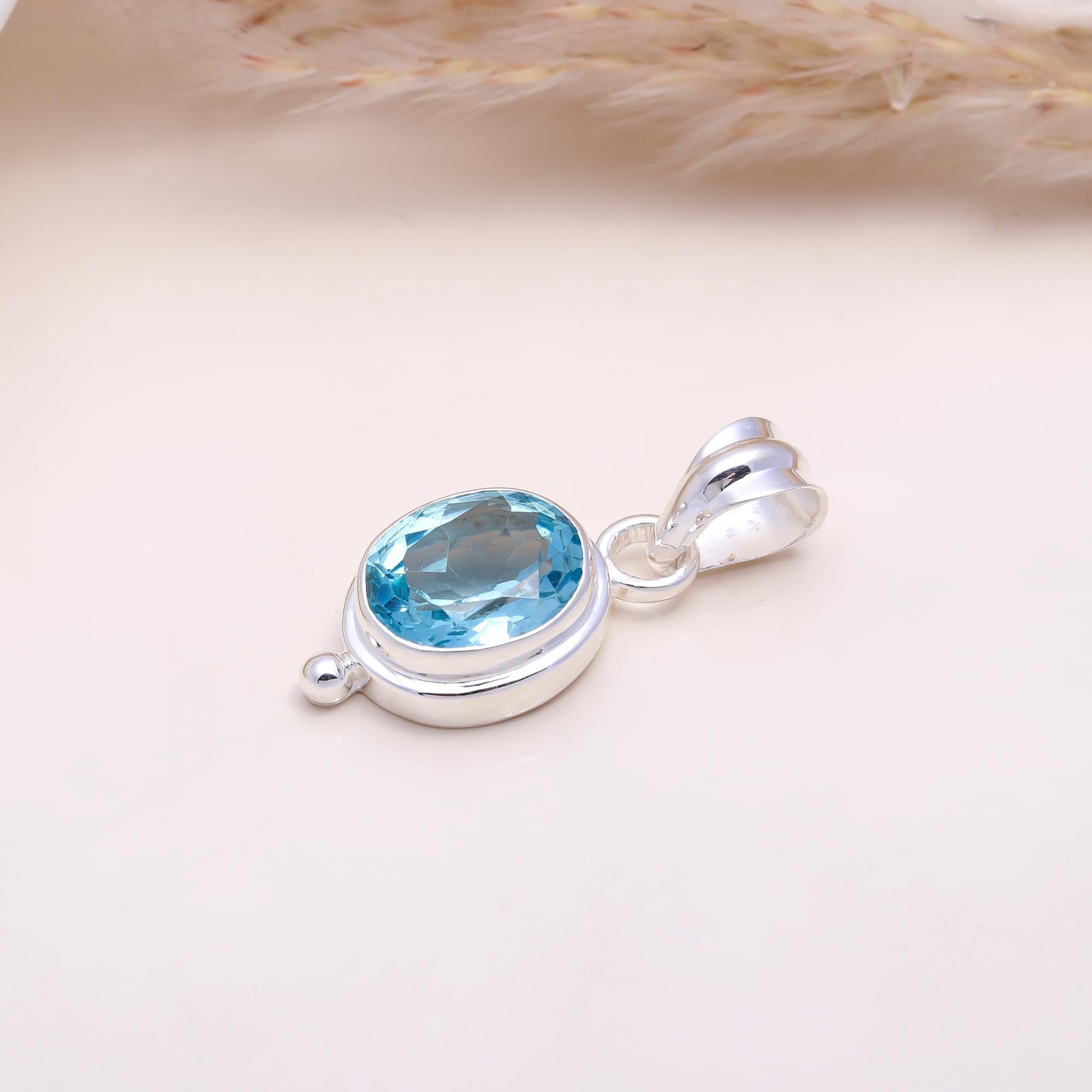 The Serene Oval: Blue Topaz East-West Pendant