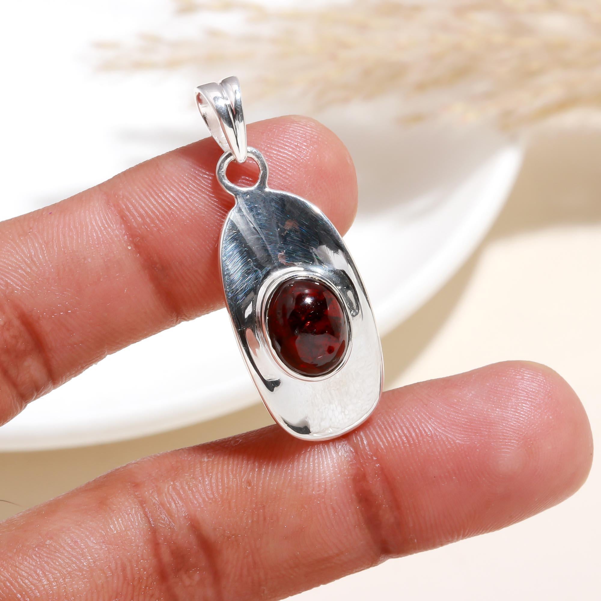 The Sculptural Shield: Modern Garnet Polished Silver Pendant