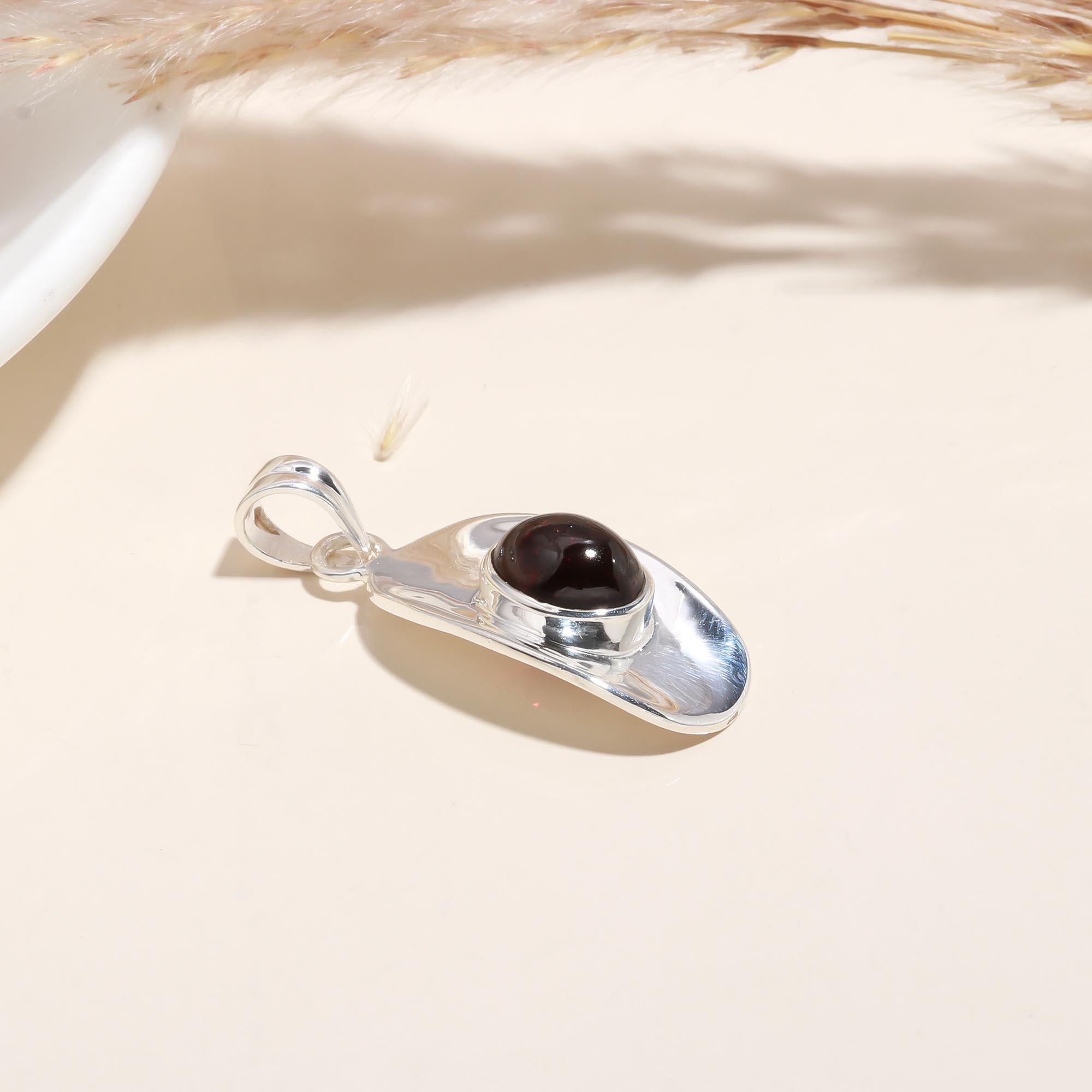 The Sculptural Shield: Modern Garnet Polished Silver Pendant