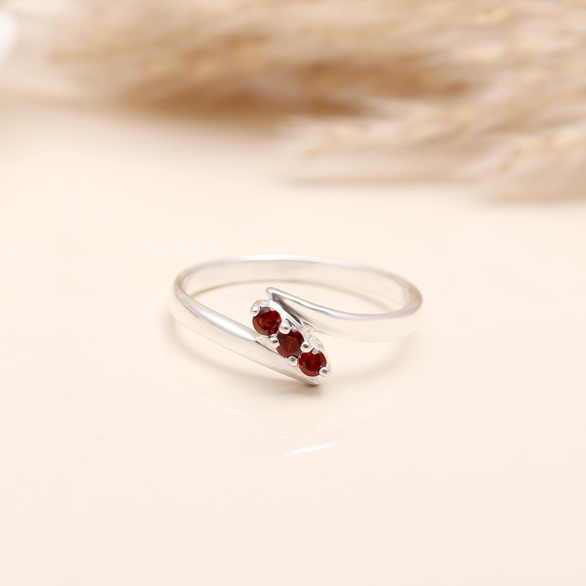 Handcrafted sterling silver overlapping band garnet ring