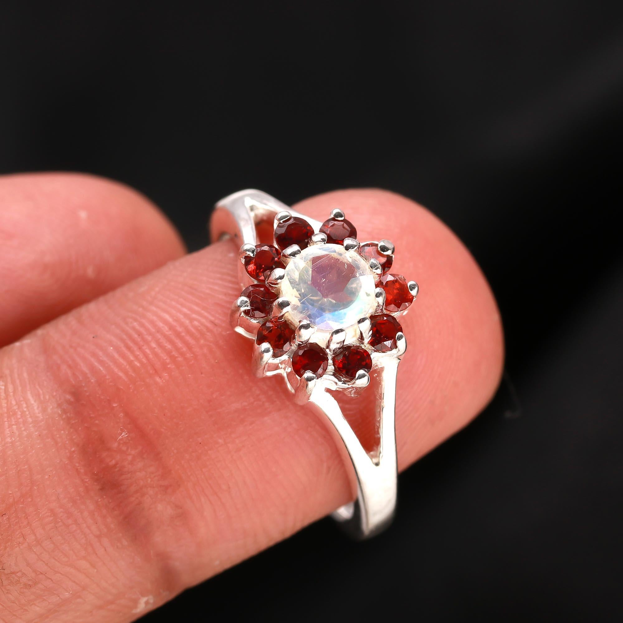 Floral silver ring with moonstone centre and garnet accents