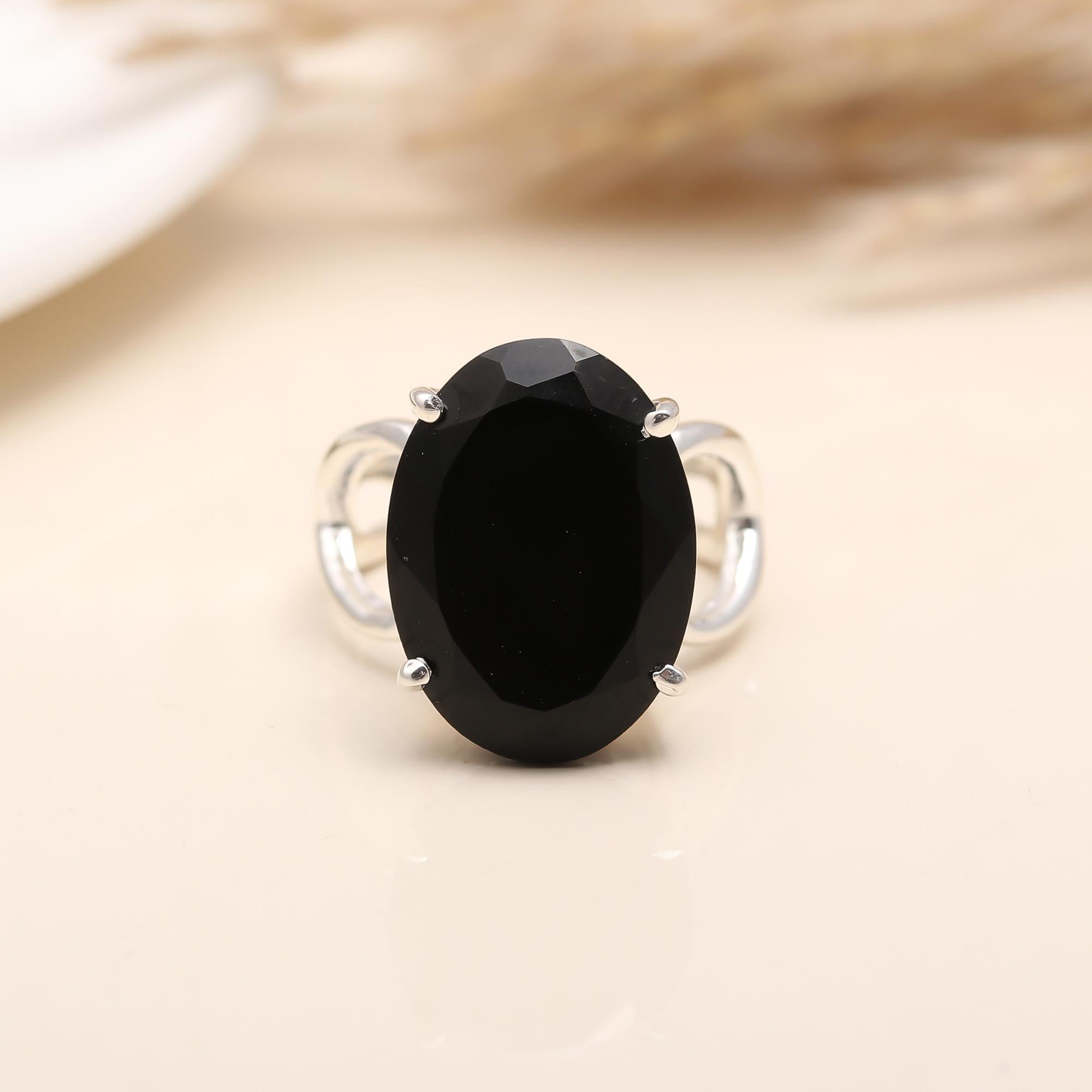 Elegant oval black onyx gemstone ring in silver setting