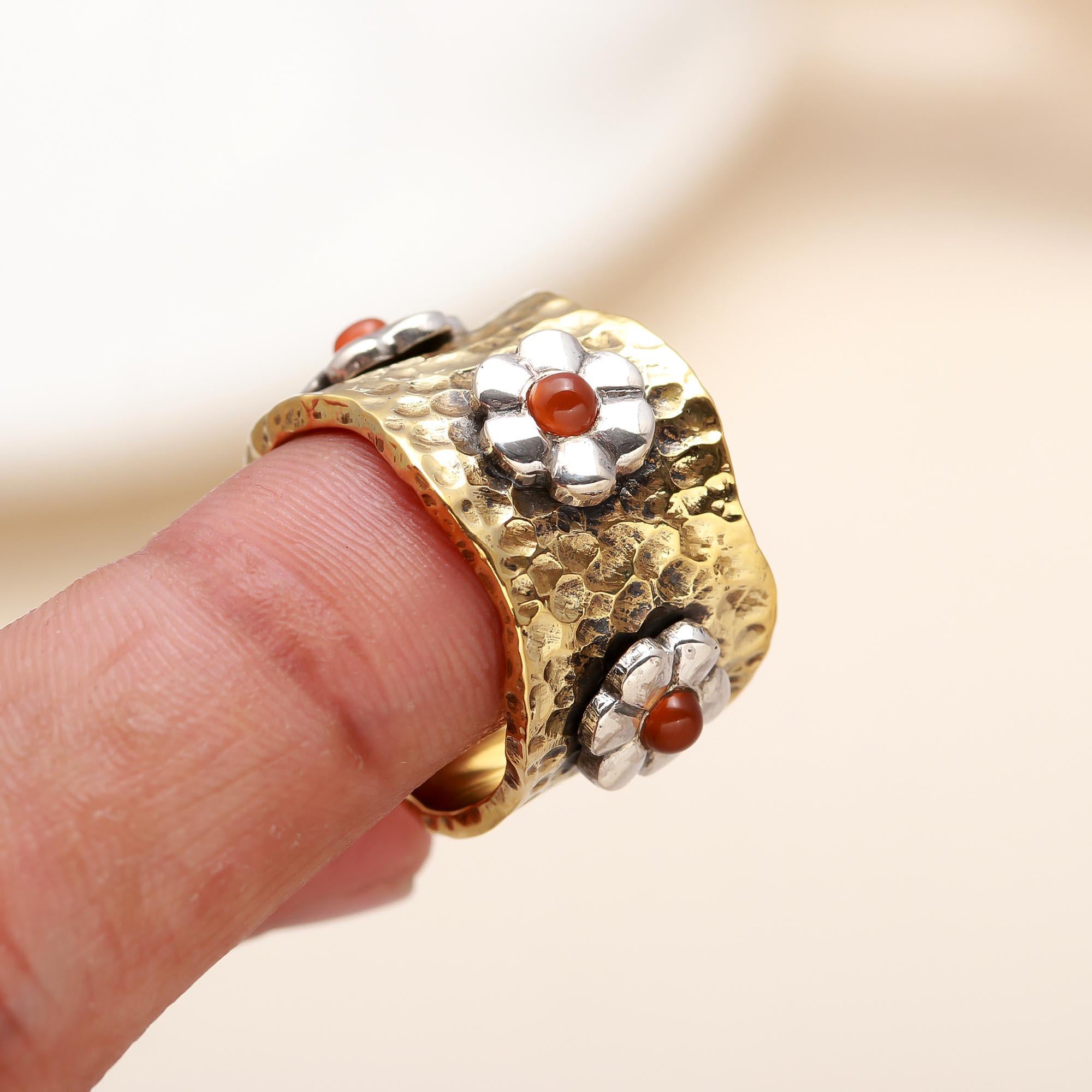 Nature-inspired silver and carnelian ring on finger