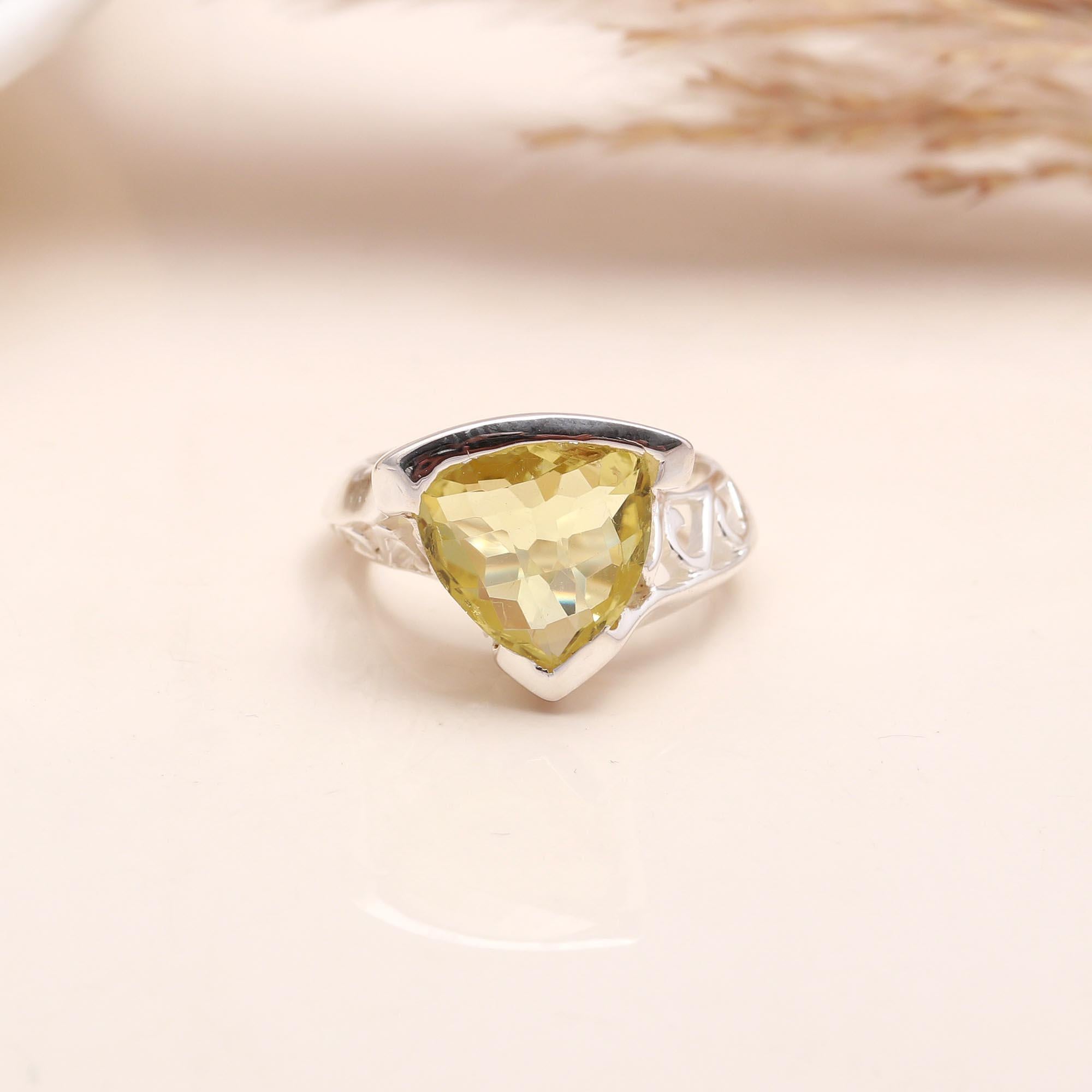 Close-up of trillion cut lemon quartz silver filigree ring