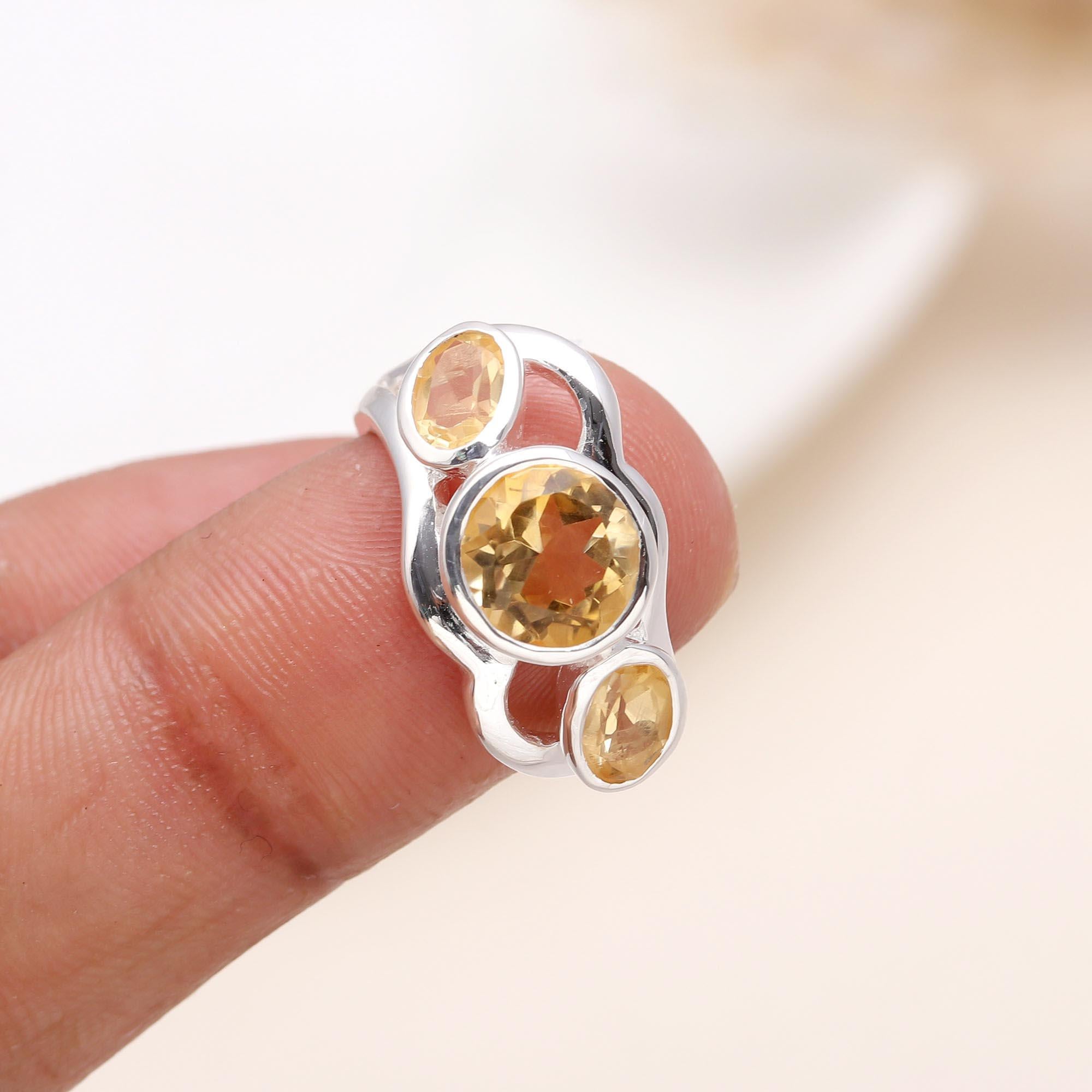 Elegant three-stone citrine ring on finger