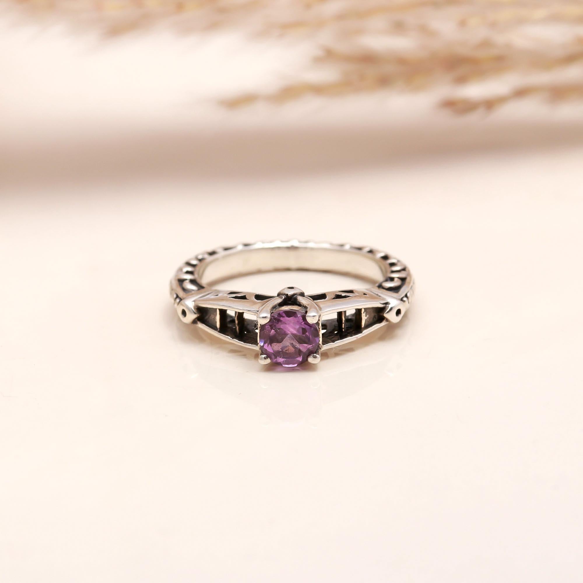 Close-up of amethyst with red enamel silver ring