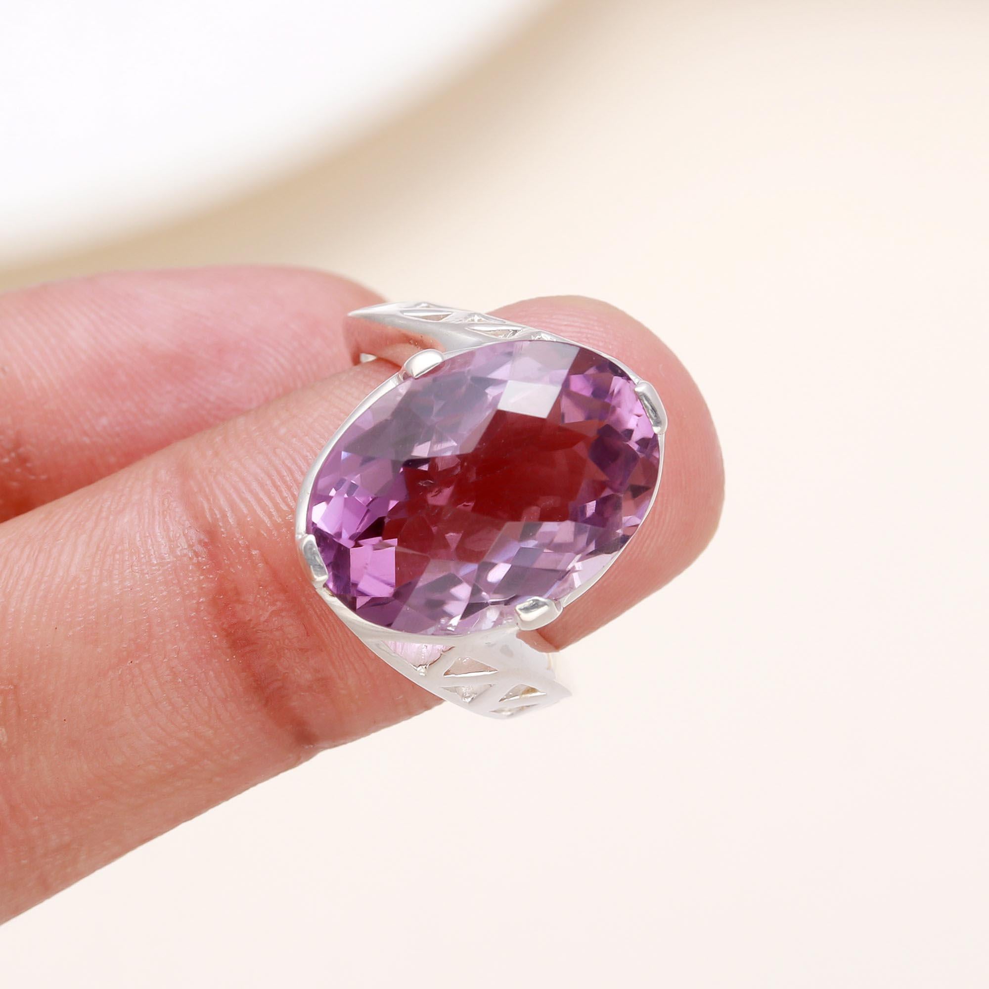 Purple amethyst oval ring displayed on finger 