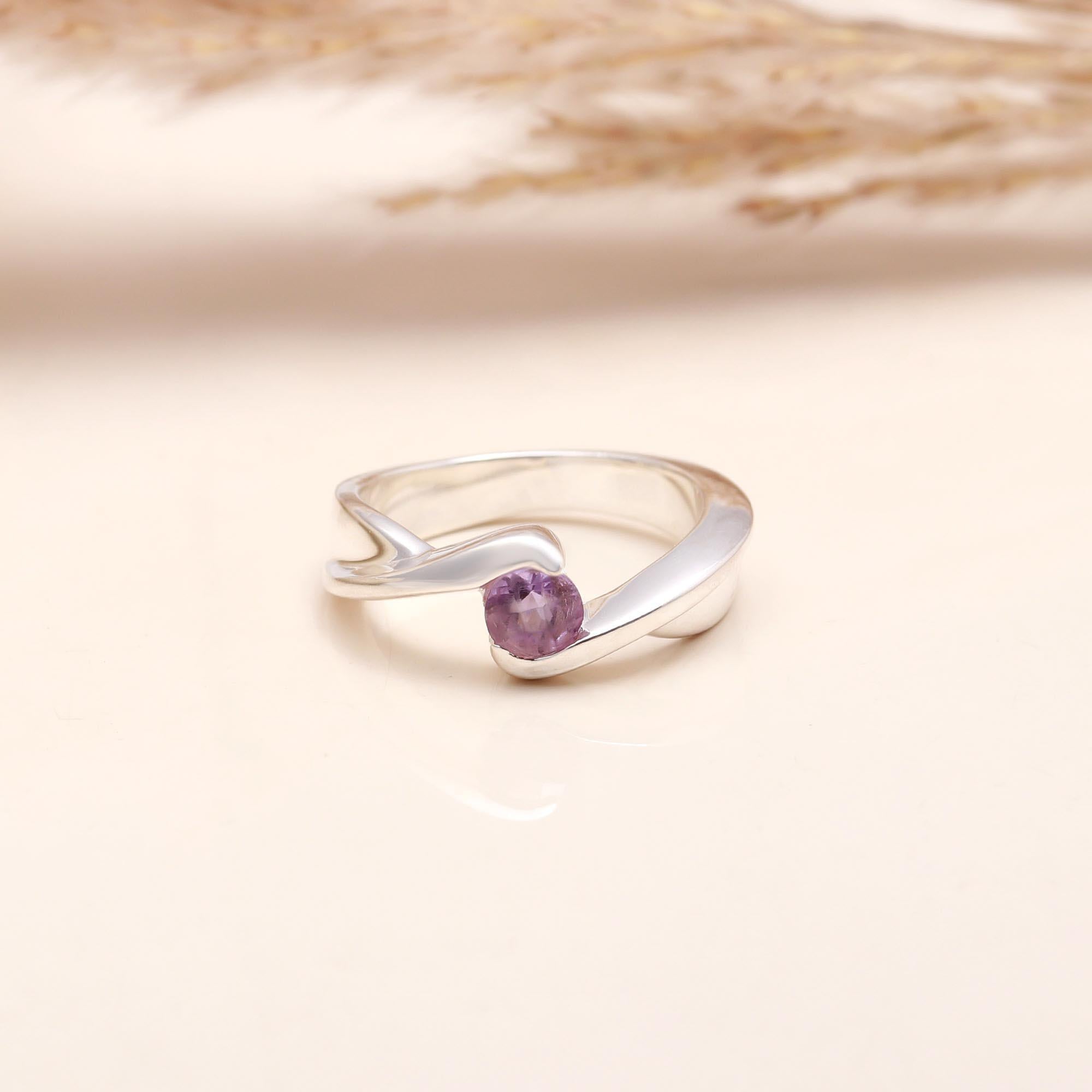 Round-cut amethyst set in bypass sterling silver band