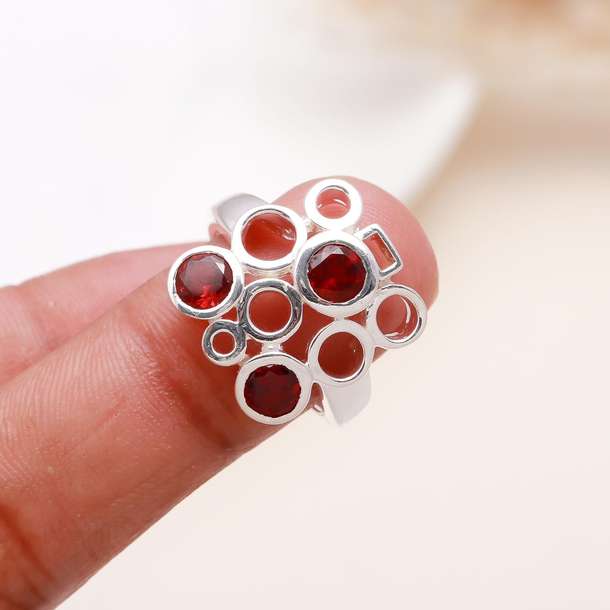 Elegant red garnet geometric design ring on finger