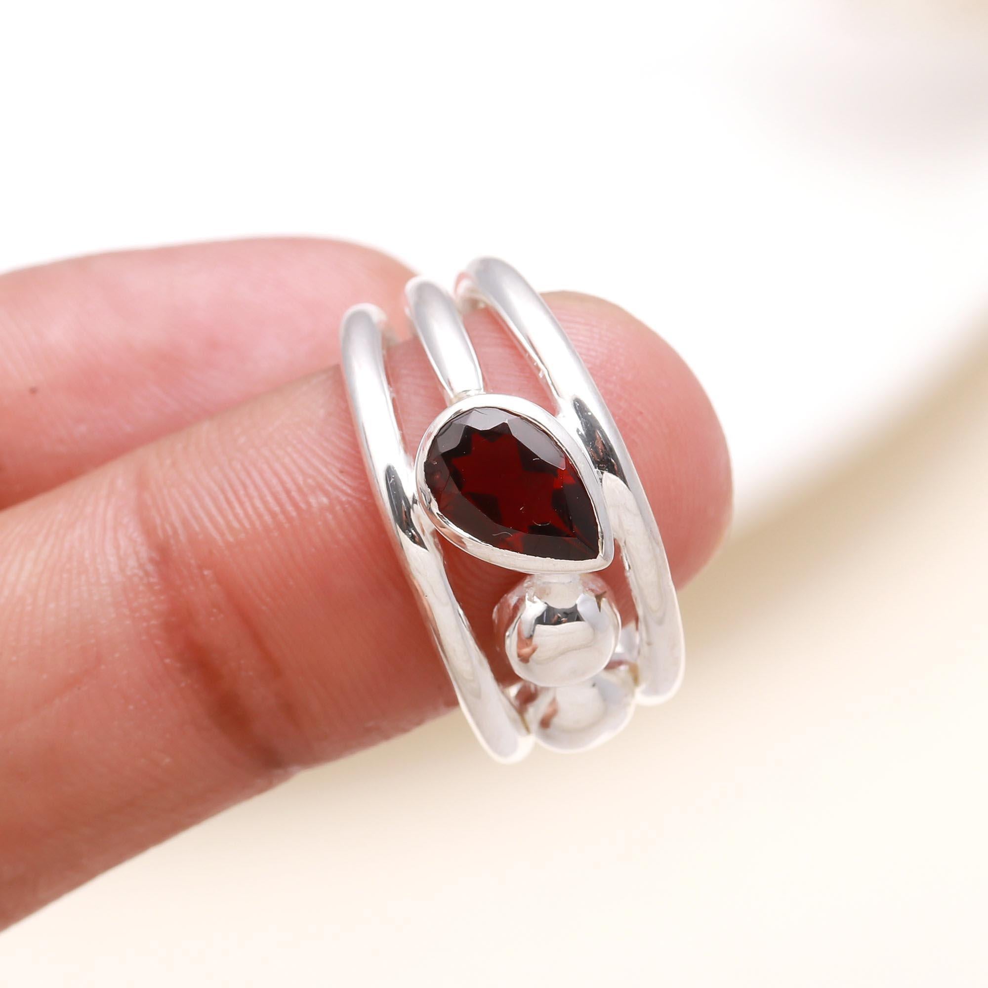 Elegant garnet gemstone split band ring on finger