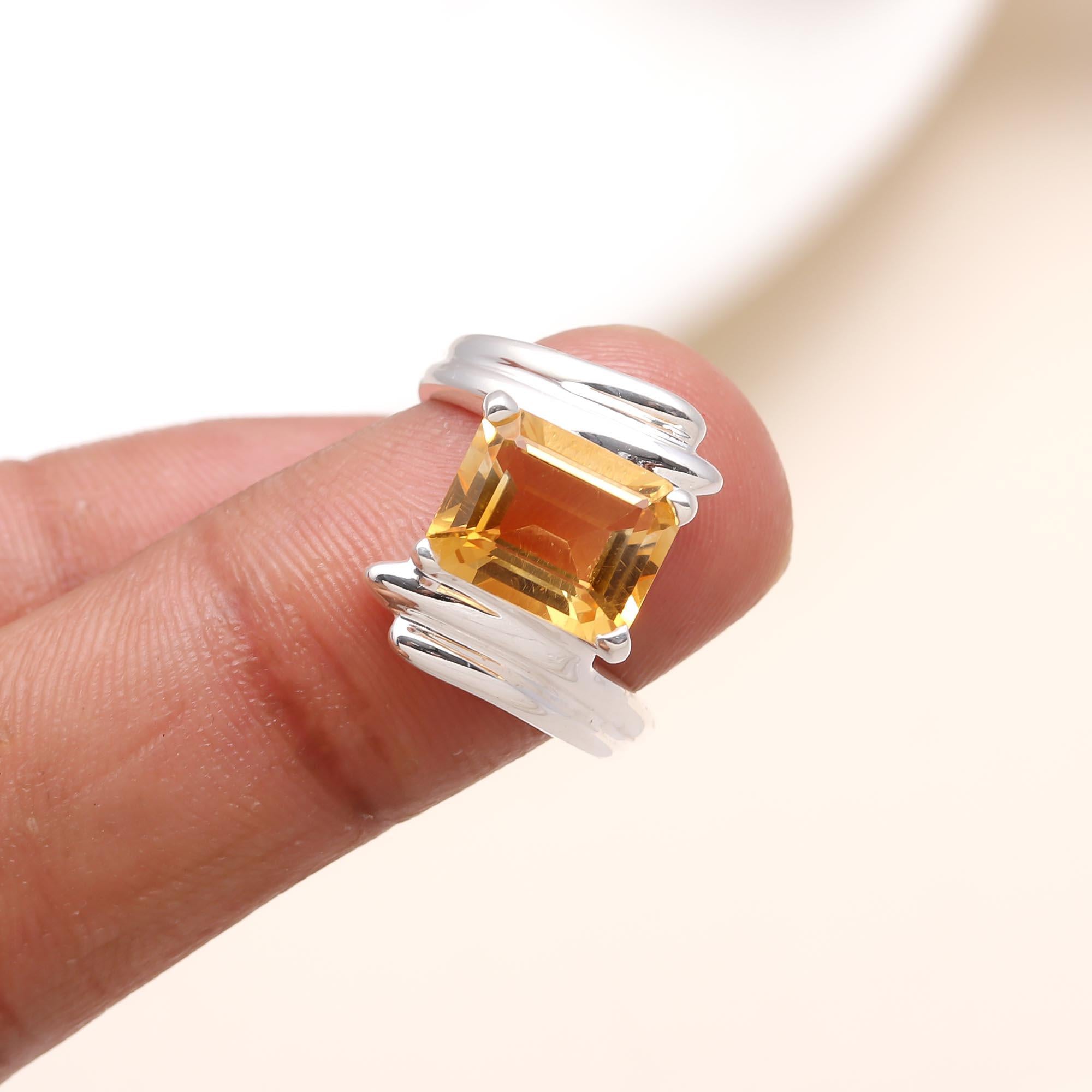 Elegant emerald-cut citrine gemstone ring on finger