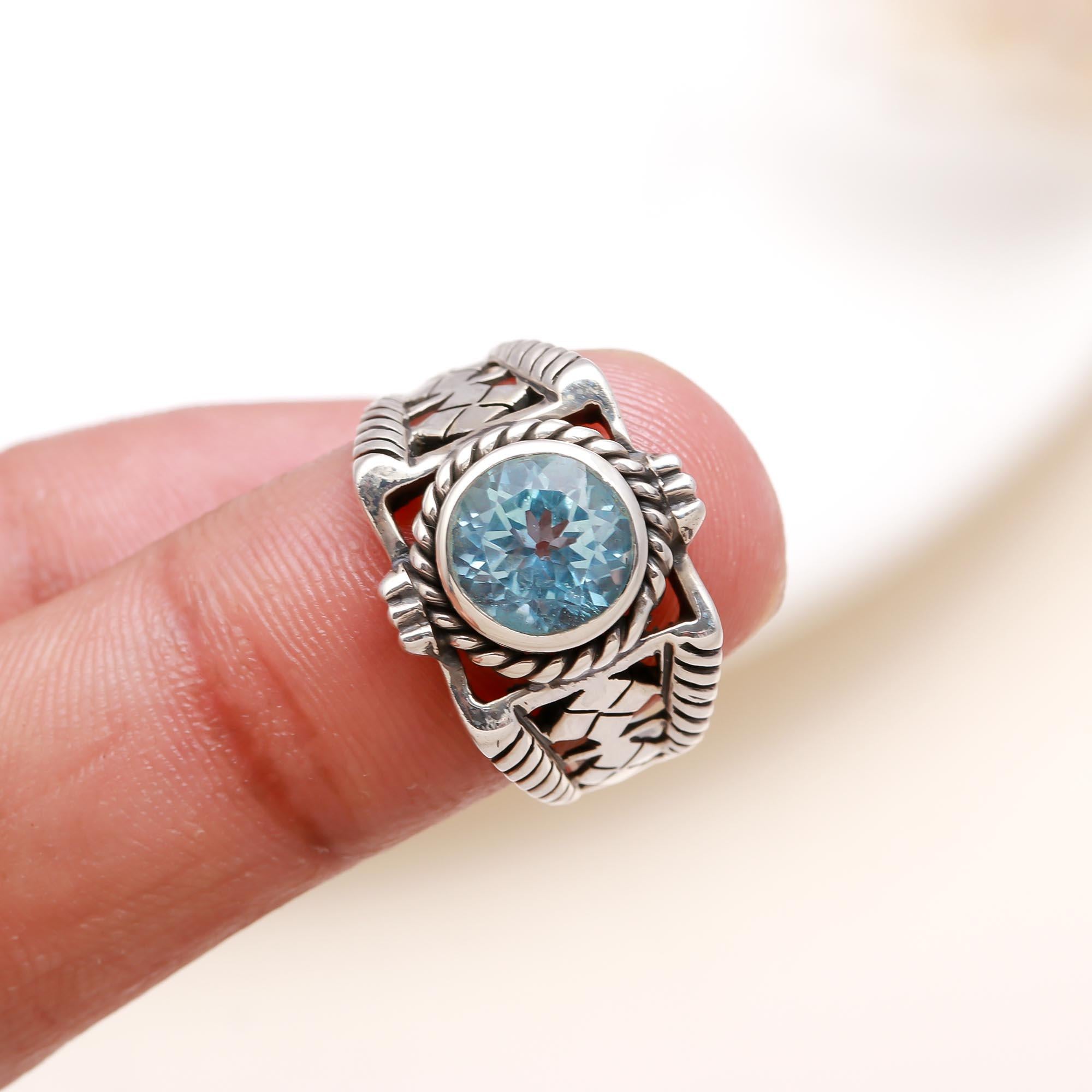 Elegant round blue topaz gemstone ring on finger