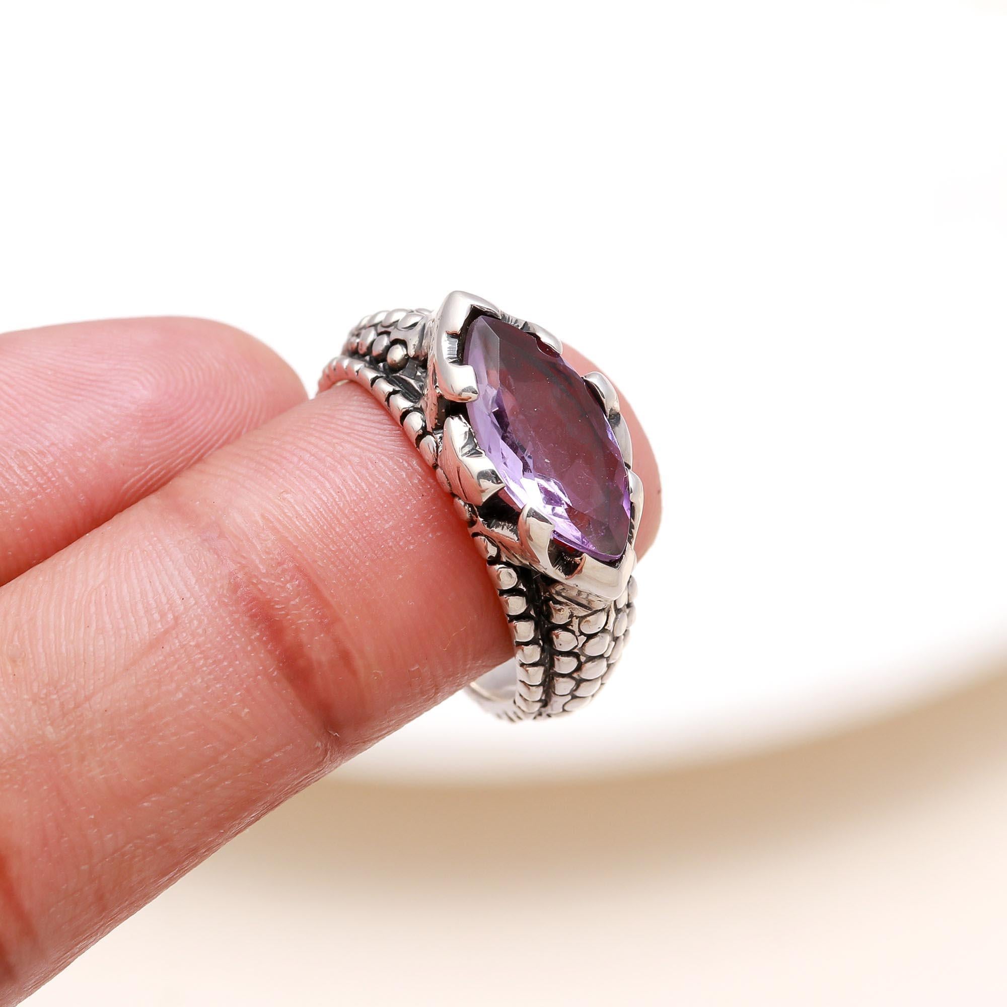 Elegant marquise cut amethyst ring on finger
